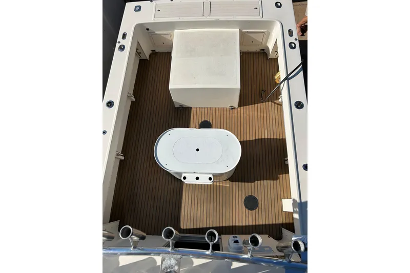 Slide: The Image of Parker 2520 XLD Sport Cabin 2000 boat deck with wood finish and storage compartments. - 8