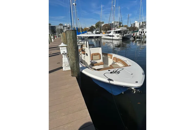 Slide: The Image of 2023 NauticStar 28 XS boat docked at a marina with clear blue skies. - 4