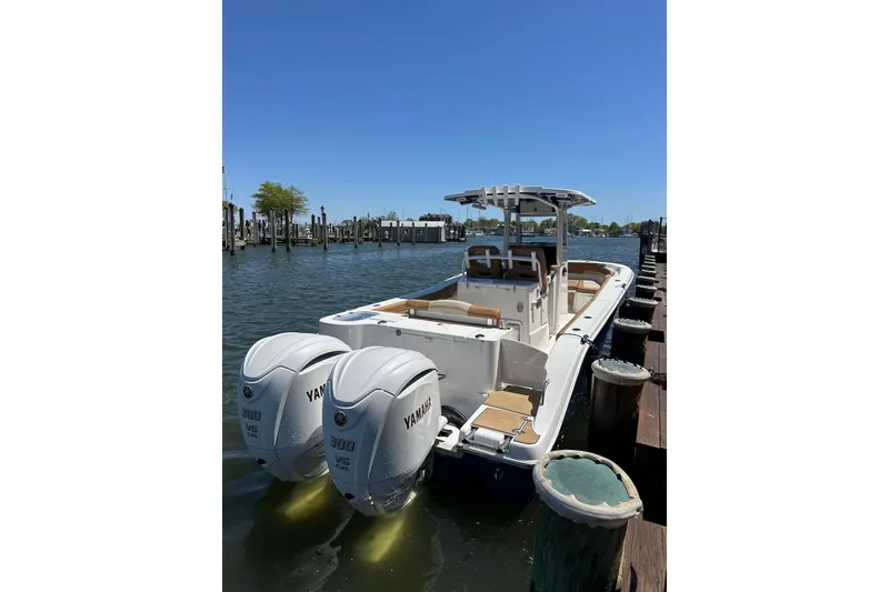 Slide: The Image of 2023 NauticStar 28 XS boat docked with twin Yamaha engines. - 5