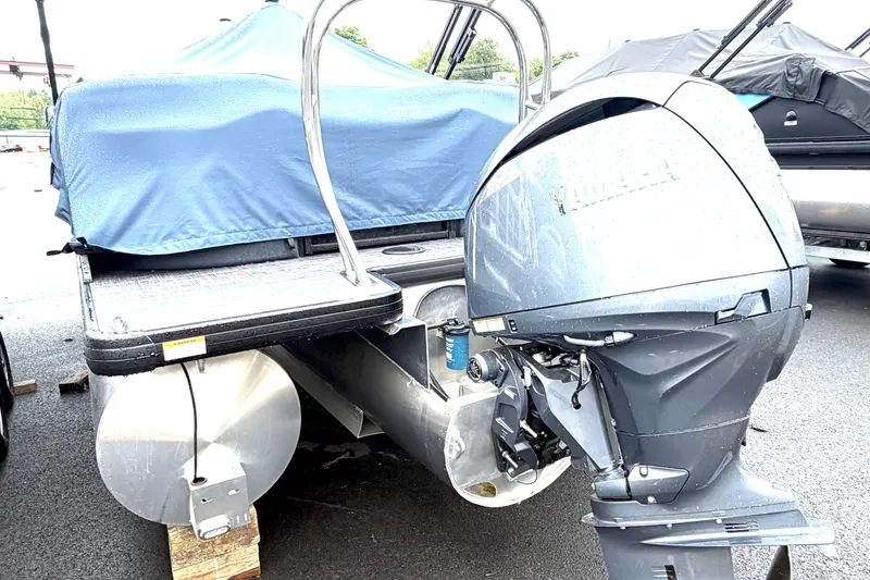Slide: The Image of 2026 Godfrey Sweetwater 2286 SBC pontoon boat with Yamaha outboard motor, covered and parked. - 11