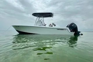 The Image of 2024 Contender 25 Tournament boat on calm water under cloudy sky. - 0