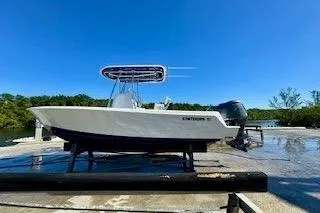 Slide: The Image of 2024 Contender 25 Tournament boat on a dock under clear blue sky. - 1