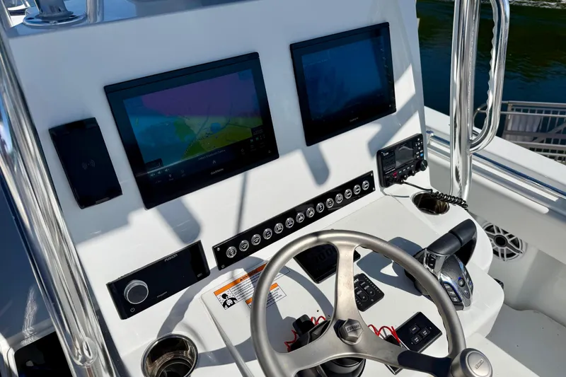 Slide: The Image of 2024 Contender 25 Tournament boat dashboard with navigation screens and controls. - 10