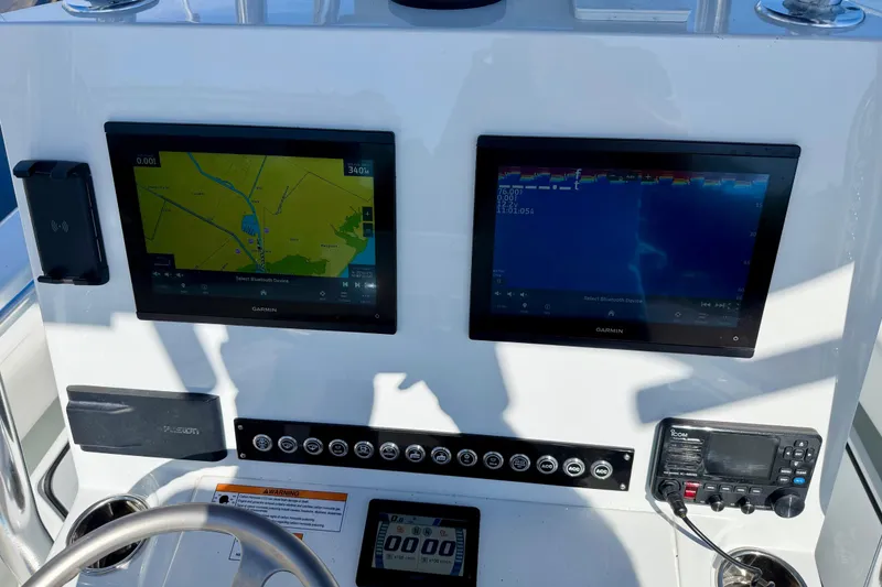 Slide: The Image of Dashboard of 2024 Contender 25 Tournament boat with navigation and sonar displays. - 11