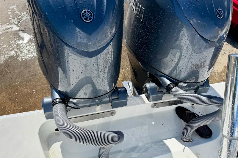 Slide: The Image of 2024 Contender 25 Tournament boat with dual Yamaha outboard motors, wet with water droplets. - 12