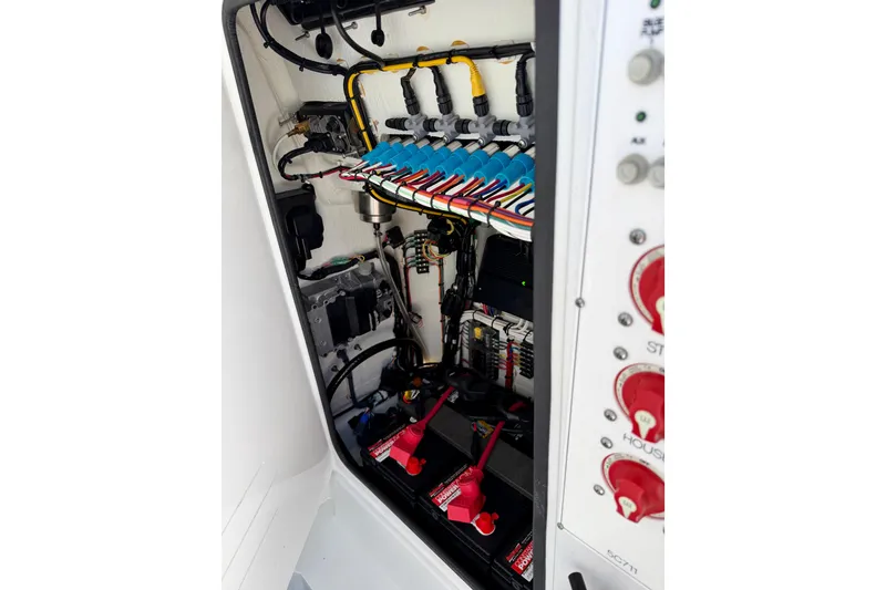 Slide: The Image of 2024 Contender 25 Tournament boat electrical system with organized wiring and battery setup. - 15