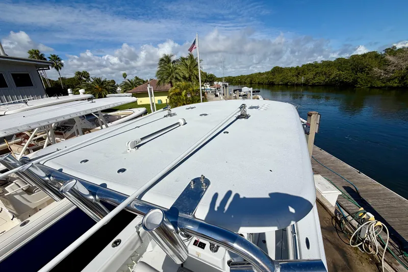 Slide: The Image of 2024 Contender 25 Tournament boat docked by a scenic waterfront with clear skies. - 16