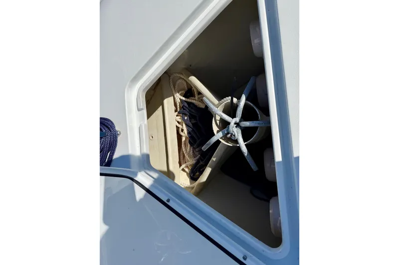 Slide: The Image of Anchor storage compartment on 2024 Contender 25 Tournament boat with ropes and anchor. - 17