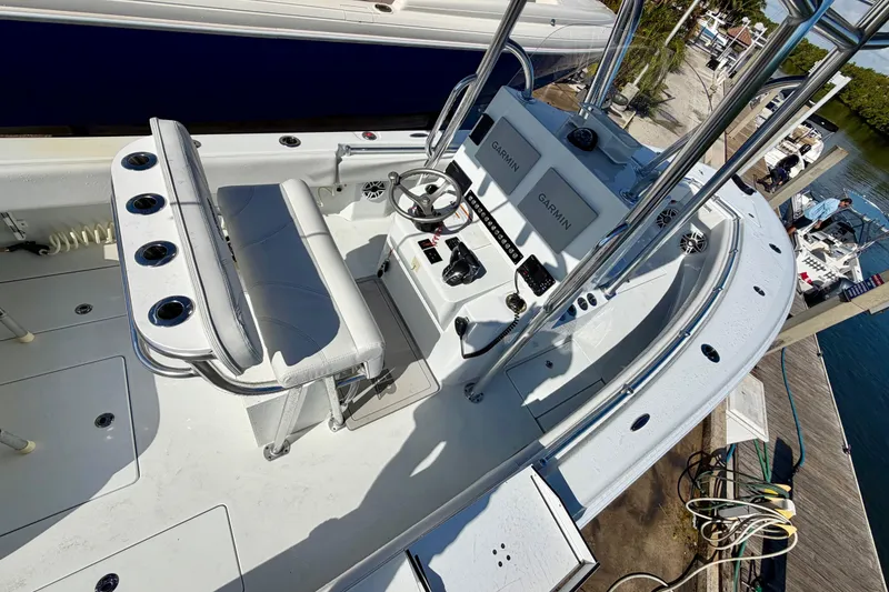 Slide: The Image of 2024 Contender 25 Tournament boat interior with helm, seating, and Garmin electronics. - 6