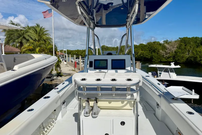 Slide: The Image of 2024 Contender 25 Tournament boat with dual screens, docked near lush greenery. - 8