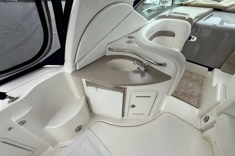 Slide: The Image of 2003 Sea Ray 320 Sundancer interior with sink and seating area. - 10