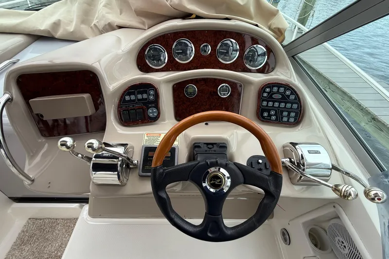 Slide: The Image of Cockpit of 2003 Sea Ray 320 Sundancer with steering wheel and control panel. - 15