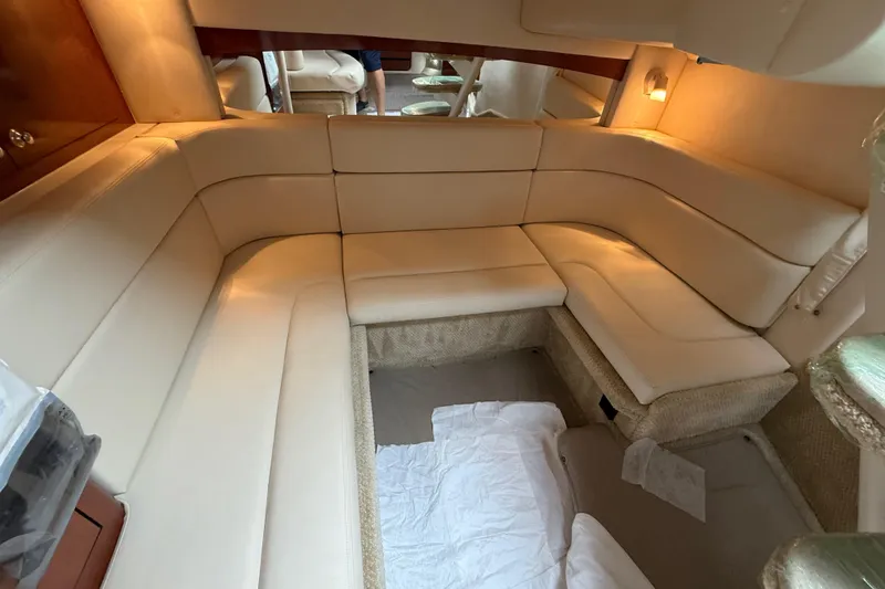 Slide: The Image of Interior of 2003 Sea Ray 320 Sundancer with beige seating and ambient lighting. - 23