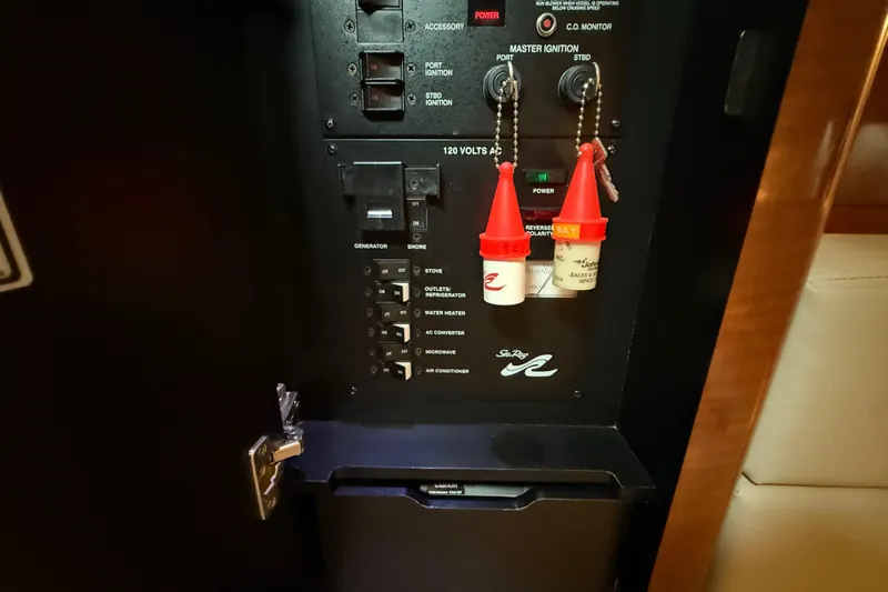 Slide: The Image of Electrical panel of a 2003 Sea Ray 320 Sundancer boat with ignition keys. - 26