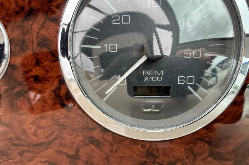 Slide: The Image of Close-up of 2003 Sea Ray 320 Sundancer RPM gauge on wood grain dashboard. - 27