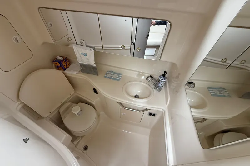 Slide: The Image of Bathroom interior of 2003 Sea Ray 320 Sundancer yacht, featuring sink and toilet. - 29