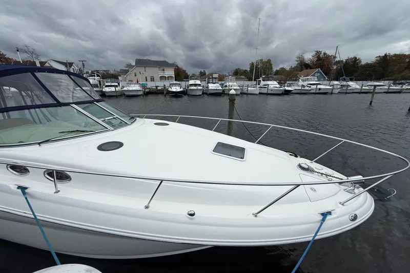 Slide: The Image of 2003 Sea Ray 320 Sundancer docked at marina under cloudy skies. - 3