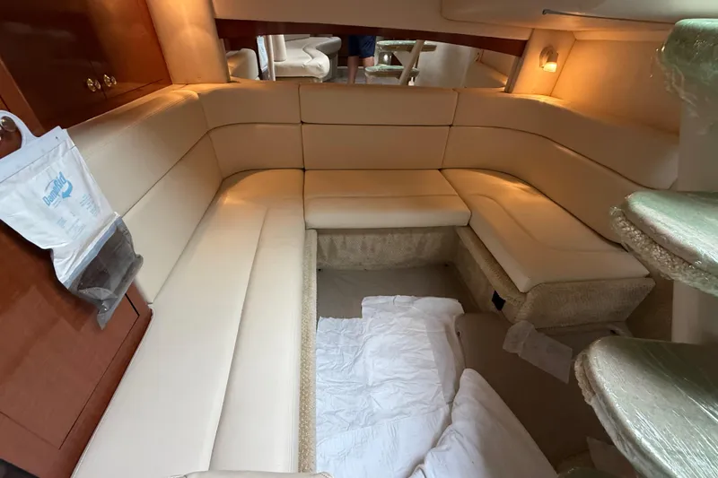 Slide: The Image of Luxurious interior of 2003 Sea Ray 320 Sundancer with beige seating and ambient lighting. - 30