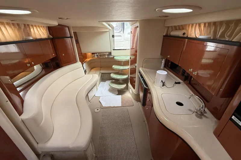 Slide: The Image of Luxurious interior of 2003 Sea Ray 320 Sundancer yacht with elegant seating and kitchenette. - 36