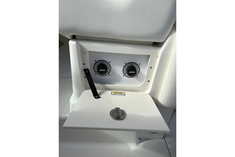 Slide: The Image of 2003 Sea Ray 320 Sundancer boat interior with control panel and storage compartment. - 39