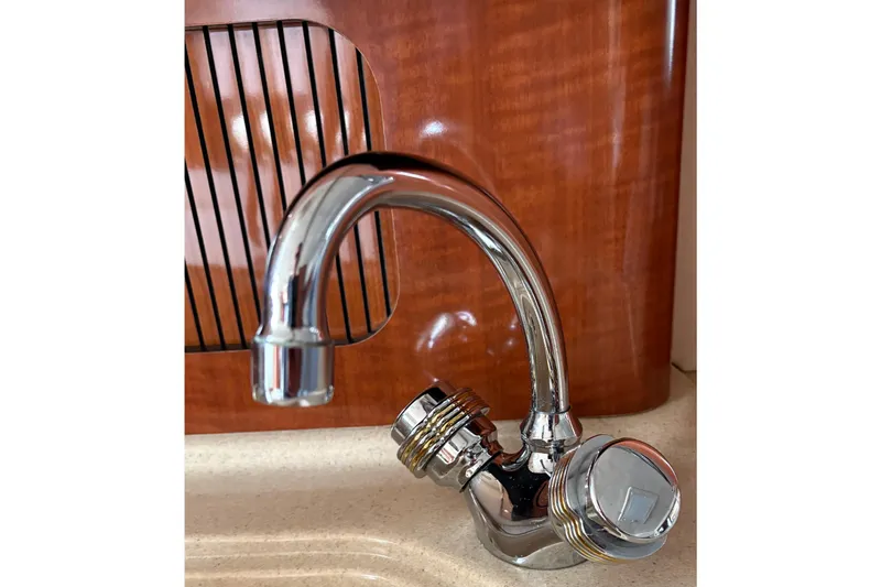 Slide: The Image of Chrome faucet on 2003 Sea Ray 320 Sundancer yacht, wooden panel background. - 41