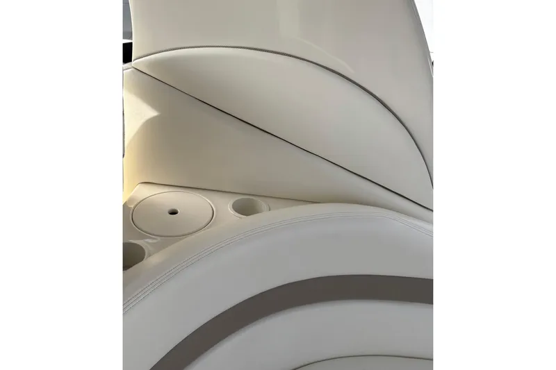 Slide: The Image of 2003 Sea Ray 320 Sundancer interior with white leather seating and cup holders. - 42