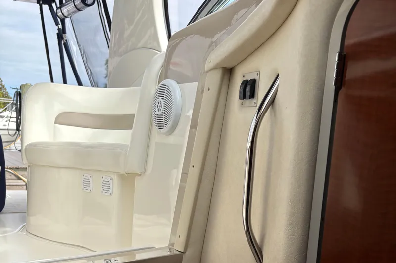 Slide: The Image of Interior view of 2003 Sea Ray 320 Sundancer boat, featuring seating and control panel. - 44