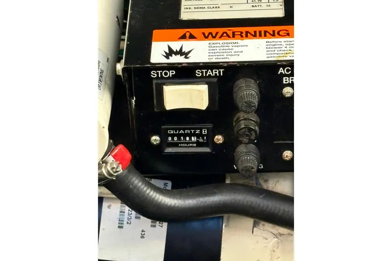 Slide: The Image of Control panel of 2003 Sea Ray 320 Sundancer with warning label and hour meter. - 46