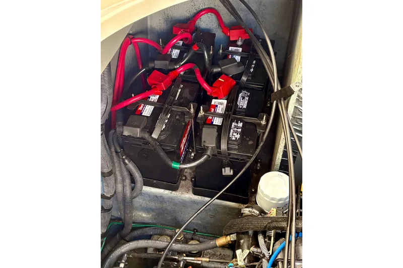 Slide: The Image of Battery compartment of a 2003 Sea Ray 320 Sundancer with red cables and wiring. - 47