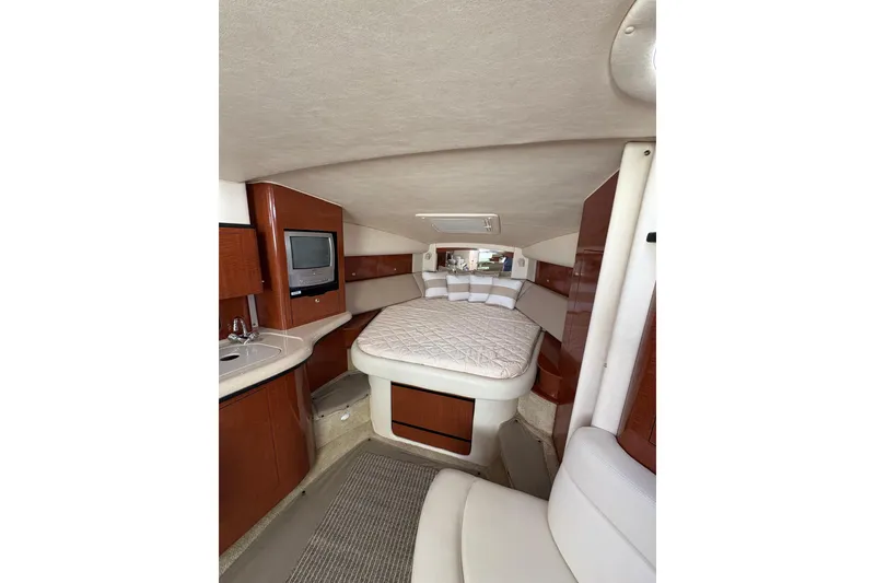 Slide: The Image of Interior of 2003 Sea Ray 320 Sundancer with bed, TV, and kitchenette. - 48