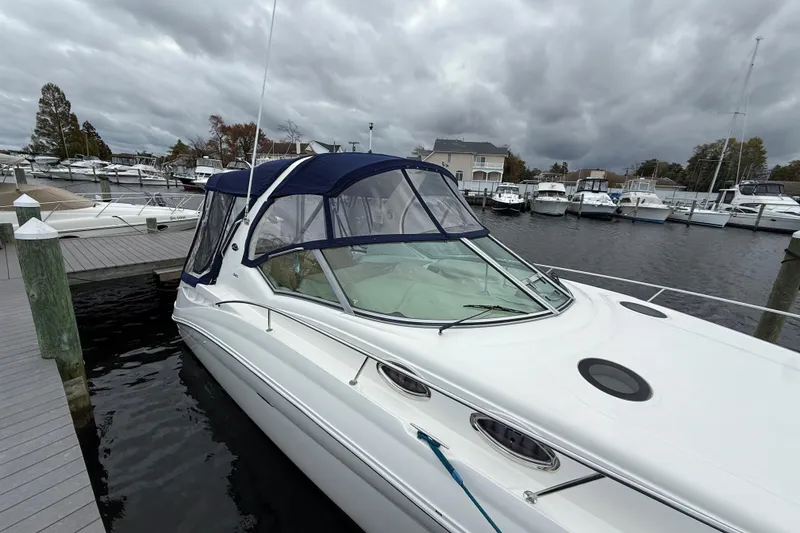 Slide: The Image of 2003 Sea Ray 320 Sundancer docked at marina under cloudy skies. - 5