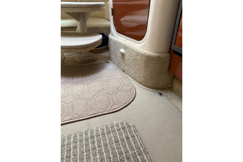 Slide: The Image of Interior of 2003 Sea Ray 320 Sundancer with beige carpet and seating area. - 52