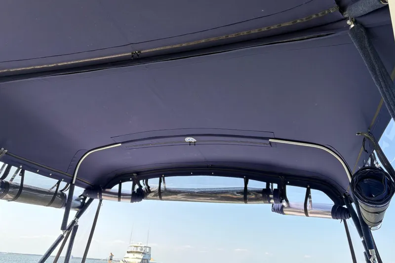 Slide: The Image of Bimini top of 2003 Sea Ray 320 Sundancer with ocean view in background. - 58