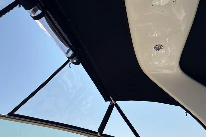 Slide: The Image of 2003 Sea Ray 320 Sundancer boat canopy and roof detail against clear sky. - 59