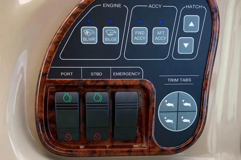 Slide: The Image of Control panel of a 2003 Sea Ray 320 Sundancer boat with various switches and buttons. - 62