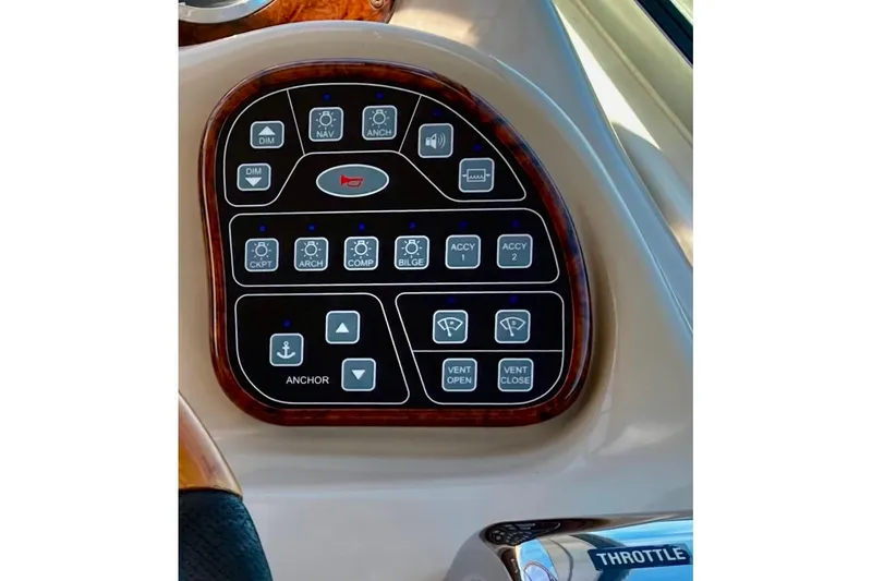 Slide: The Image of Control panel of a 2003 Sea Ray 320 Sundancer boat with various function buttons. - 63