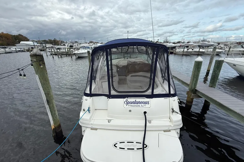 Slide: The Image of 2003 Sea Ray 320 Sundancer docked at marina under cloudy skies. - 7