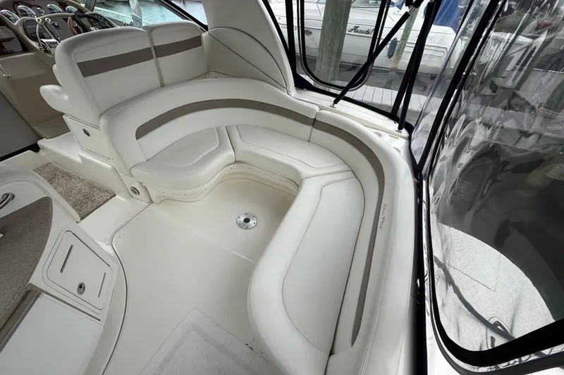 Slide: The Image of 2003 Sea Ray 320 Sundancer interior with curved seating and helm view. - 9