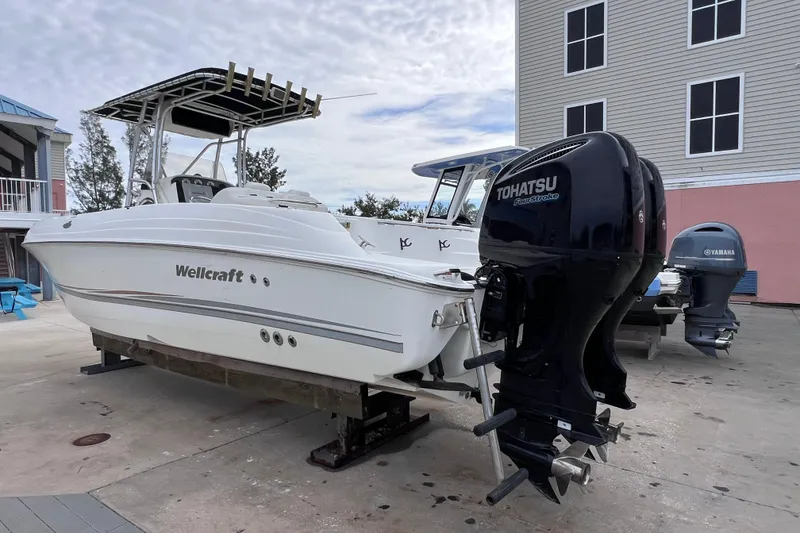 Slide: The Image of 2003 Wellcraft 29 CCF boat with Tohatsu outboard motor on display. - 11