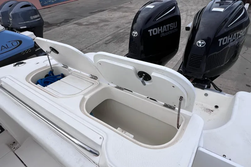 Slide: The Image of 2003 Wellcraft 29 CCF boat with open storage compartments and Tohatsu outboard engines. - 19