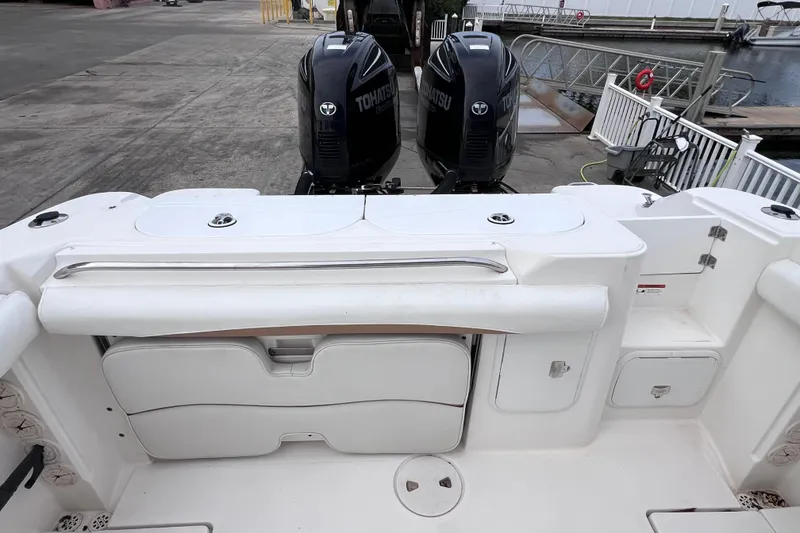 Slide: The Image of 2003 Wellcraft 29 CCF boat with dual Tohatsu engines at dockside. - 21