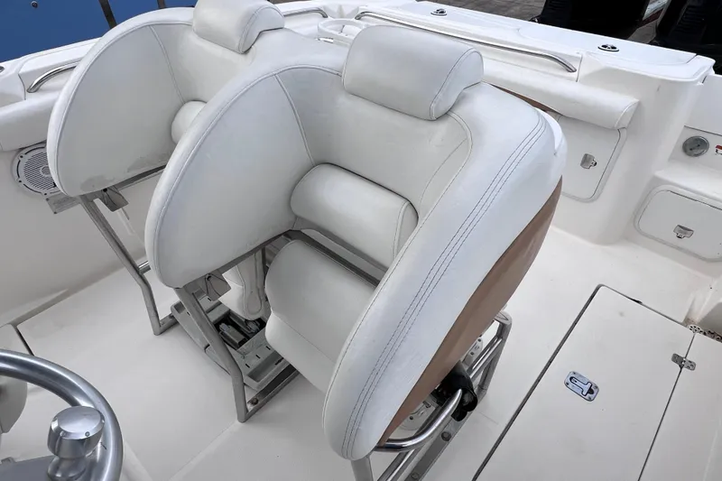 Slide: The Image of 2003 Wellcraft 29 CCF boat interior with white cushioned seating and stainless steel fixtures. - 26