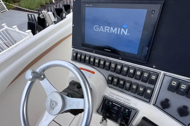 Slide: The Image of Steering console of 2003 Wellcraft 29 CCF with Garmin GPS display and control panel. - 28