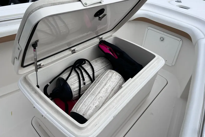 Slide: The Image of Open storage compartment on 2003 Wellcraft 29 CCF boat with fenders inside. - 35