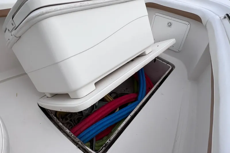 Slide: The Image of Storage compartment on a 2003 Wellcraft 29 CCF boat with colorful ropes inside. - 36
