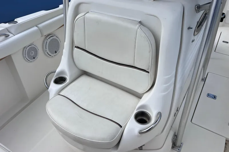 Slide: The Image of White cushioned seat on 2003 Wellcraft 29 CCF boat with cup holders and speakers. - 46