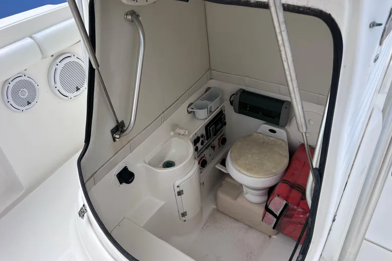 Slide: The Image of 2003 Wellcraft 29 CCF boat interior with toilet, sink, and safety equipment. - 47