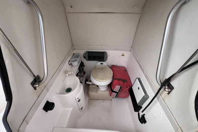 Slide: The Image of 2003 Wellcraft 29 CCF boat interior with toilet, sink, and safety equipment. - 48