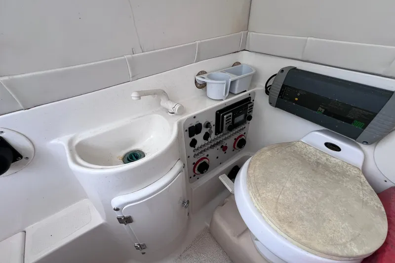 Slide: The Image of 2003 Wellcraft 29 CCF boat interior with sink, control panel, and seat. - 49