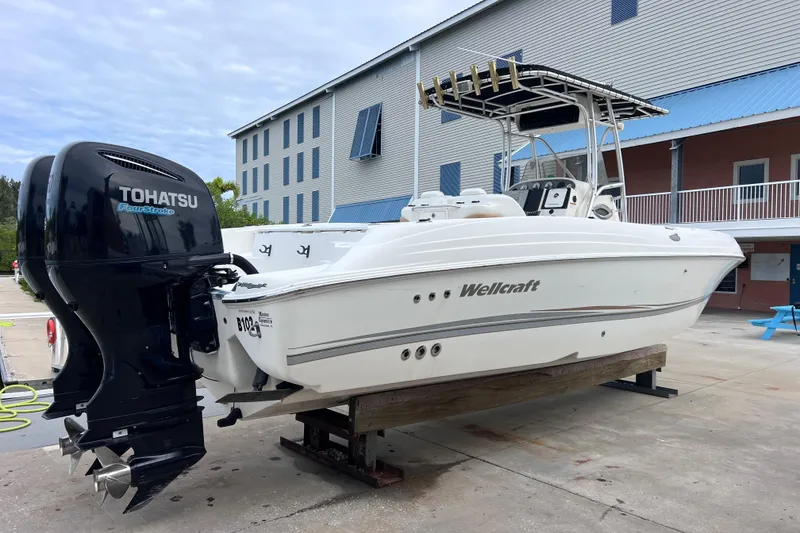 Slide: The Image of 2003 Wellcraft 29 CCF boat with Tohatsu FourStroke engine on a dock. - 5